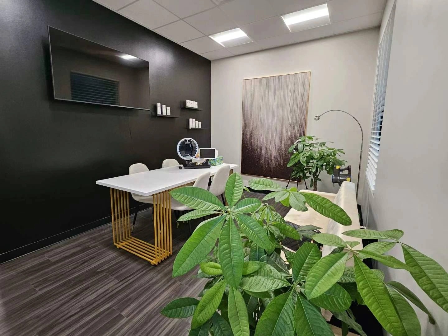 A Derma Med Spa treatment room with the studio's signature gold-base table